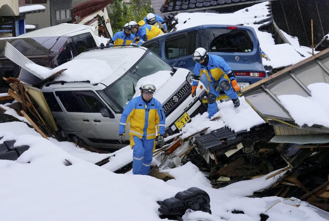 2024年1月9日，日本石川县珠洲市，警察在被地震后海啸摧毁的积雪覆盖的住宅区寻找遇难者。